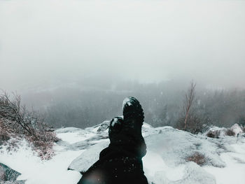 Man on snow covered land