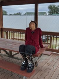 Full length of young woman sitting on seat