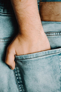 Cropped hand of man in pocket