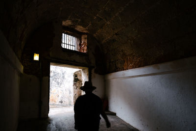 Rear view of woman standing in building