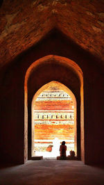 Rear view of man against wall in building