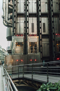 Train on railroad tracks amidst buildings in city
