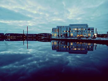 View of modern building against cloudy sky