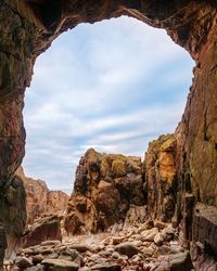 View of rock formation against cloudy sky