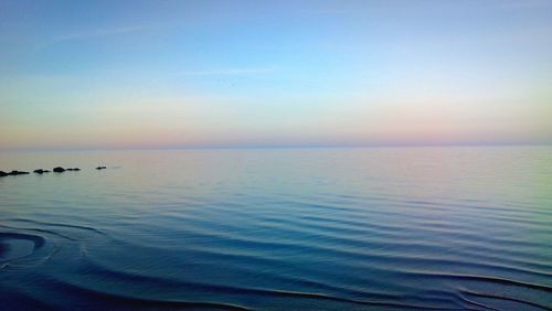 Scenic view of sea against clear sky during sunset