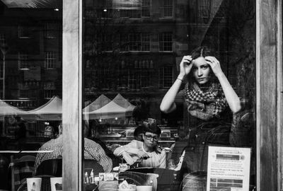 Portrait of woman standing by window