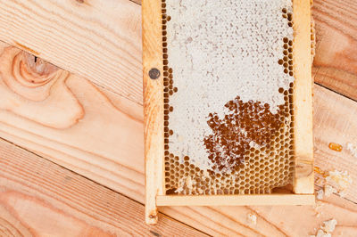 Directly above shot of beehive on wooden table