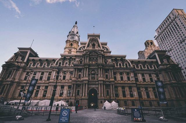 architecture, building exterior, built structure, city, low angle view, incidental people, sky, street, travel destinations, travel, famous place, day, city life, tourism, outdoors, building, blue, transportation, men