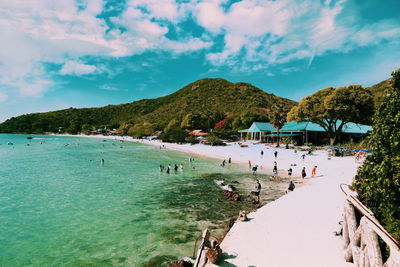 Panoramic view of people on beach against sky