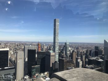 View of cityscape against cloudy sky