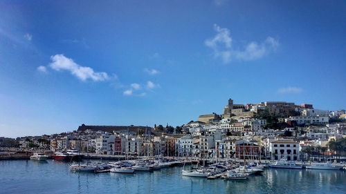 Boats in river with buildings in background