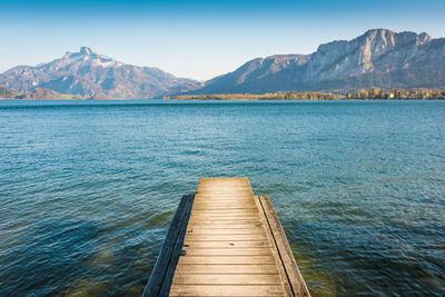 Pier over lake against mountains