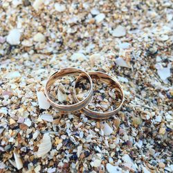 High angle view of wedding rings on rock