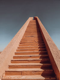 Low angle view of staircase against building against sky