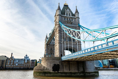 View of bridge over river against cloudy sky