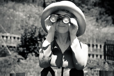 Close-up of woman looking through binoculars