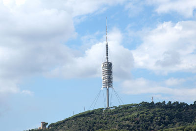 Low angle view of communications tower against sky