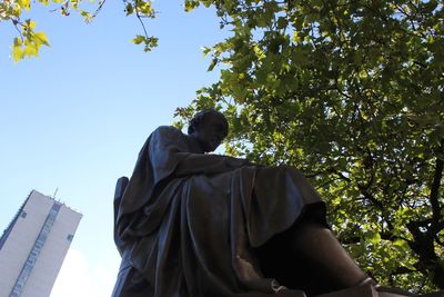 Low angle view of men against sky