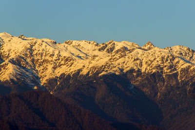 Scenic view of snowcapped mountains against clear sky