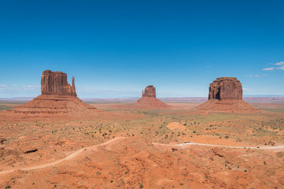Dirty road passes by the most iconic view of monument valley national park 
