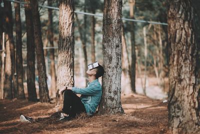 Woman using mobile phone in forest