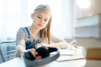 Girl sitting on table