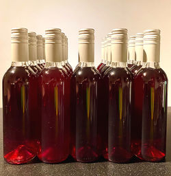 Close-up of wine bottles in glass