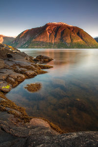 Scenic view of lake and mountains against sky