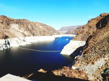 Scenic view of mountains against clear blue sky