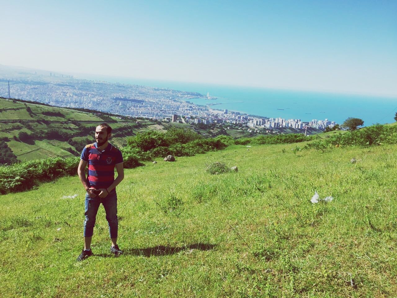 FULL LENGTH PORTRAIT OF MAN STANDING ON LANDSCAPE