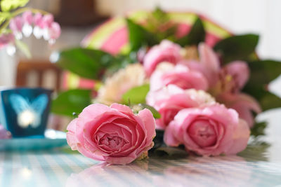 Close-up of pink roses on table