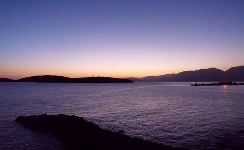 Scenic view of sea against clear sky at sunset