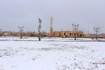 Snow covered landscape against sky