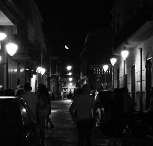 People walking on street at night