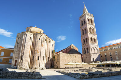 Low angle view of historic buildings against blue sky