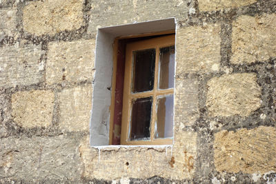 Low angle view of window on old building