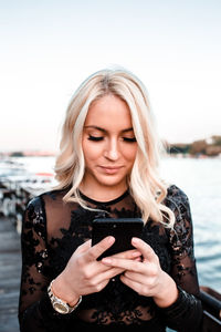 Portrait of young woman using mobile phone