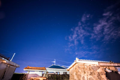 Low angle view of buildings against blue sky