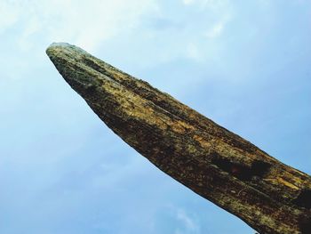 Low angle view of old metal structure against sky