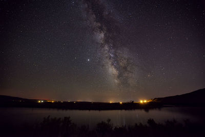 Scenic view of lake against star field at night