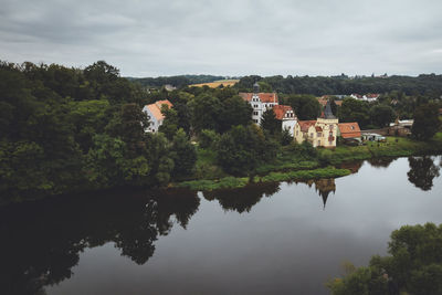 Reflection of trees and buildings on lake