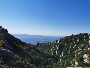 Scenic view of mountains against clear blue sky