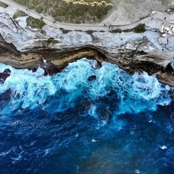 High angle view of water flowing through rocks