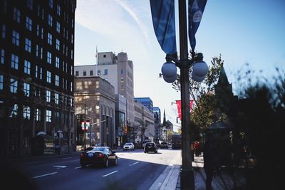 City street and buildings against sky