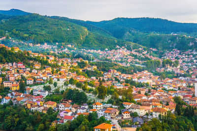 High angle view of townscape and mountain against sky