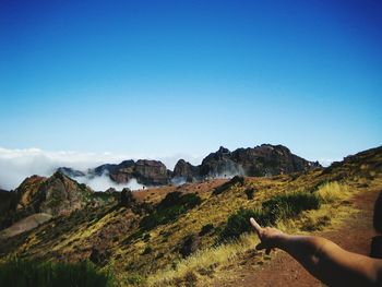 Man on mountain against clear sky