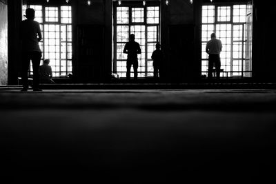 People walking in corridor of building