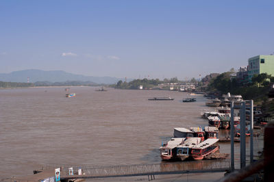 High angle view of buildings by sea against sky