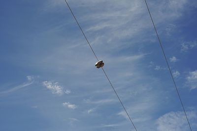 Low angle view of power lines against sky