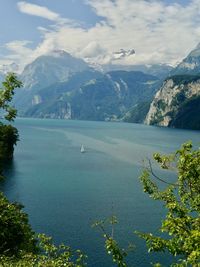 Scenic view of sea and mountains against sky